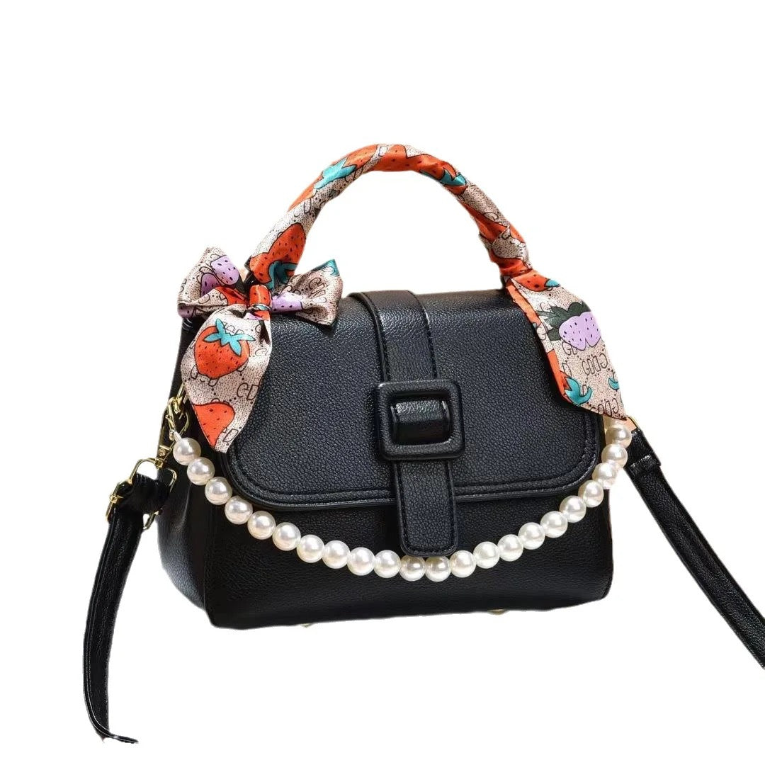 La Maricell black mini handbag with pearl detail and patterned scarf handle.