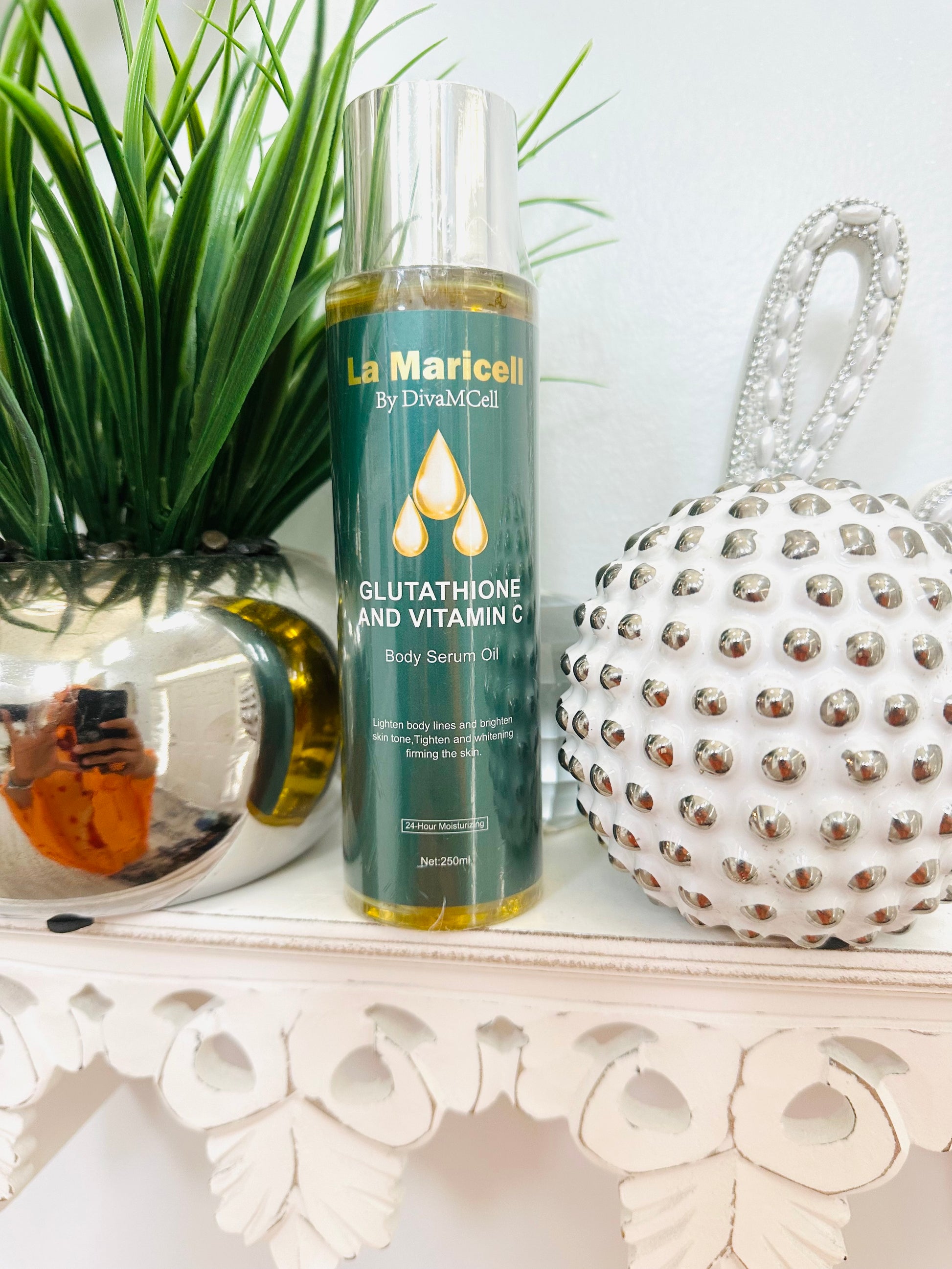 La Maricell glutathione and vitamin C body serum oil displayed on a shelf.