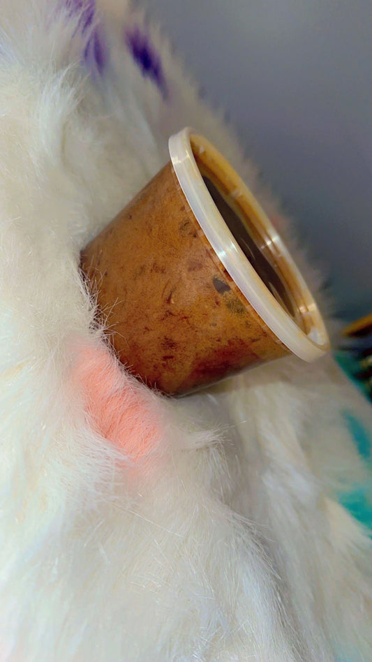 Close-up of La Maricell gourmet food in a small plastic container with rich texture.