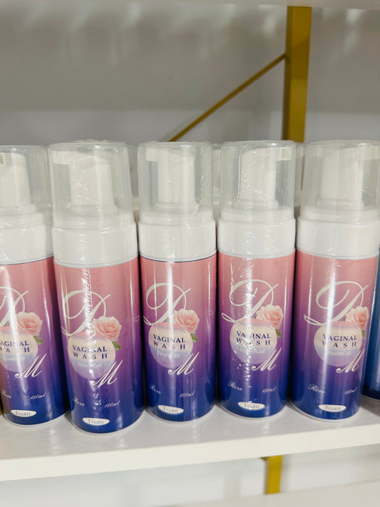 Bottles of ROSE FEMININE WASH placed side by side on a shelf, with packaging that includes the product name and images of roses.